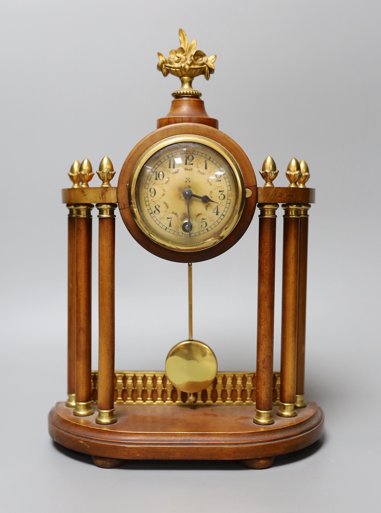 A small French portico clock with column decoration, 29cm tall